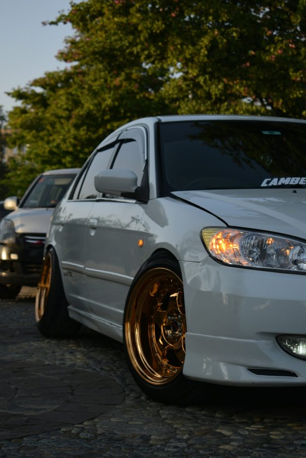 How do you accurately measure and adjust the camber angle on UK cars for improved cornering?